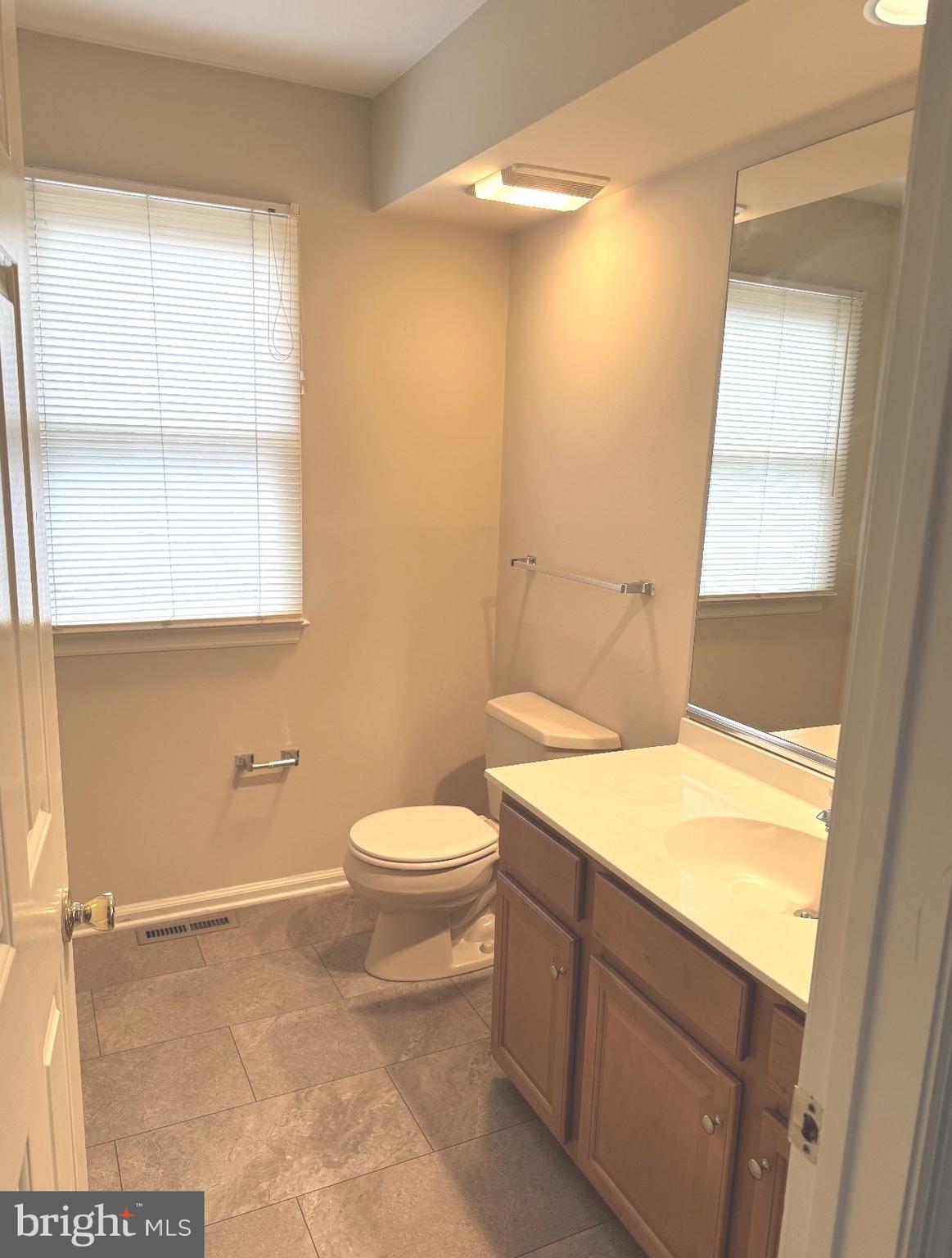 48 Beech Hill Drive Newark, DE 19711 - Photo 4 of 11 a bathroom with a sink a toilet and window