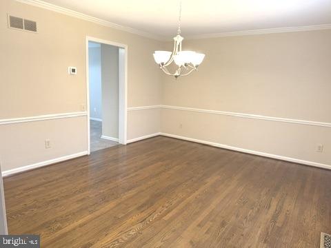 48 Beech Hill Drive Newark, DE 19711 - Photo 5 of 11 an empty room with wooden floor and chandelier
