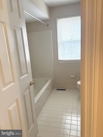 a bathroom with a tub and a window
