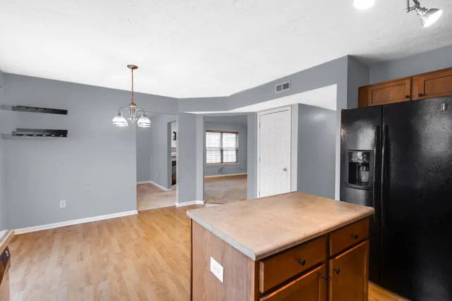 a kitchen with stainless steel appliances a refrigerator and microwave