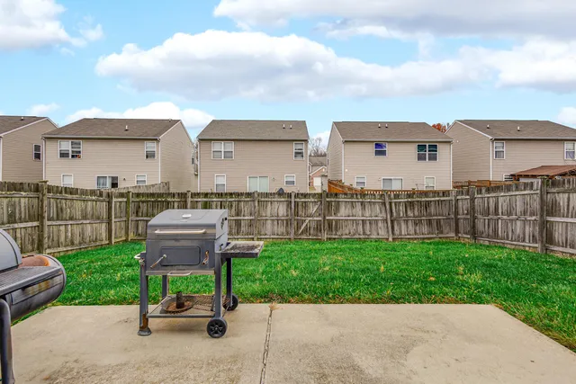 a view of a garden with wooden fence