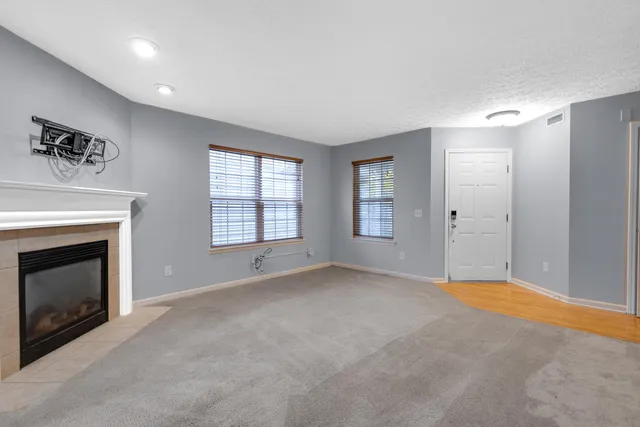 a view of an empty room with a fireplace