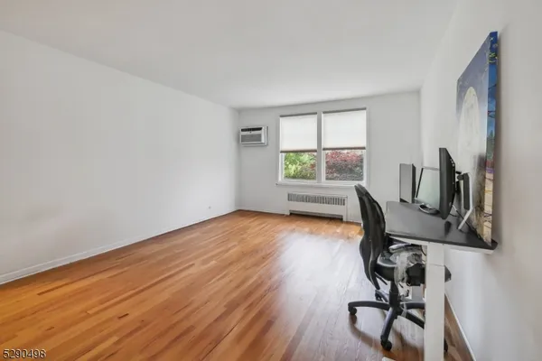 a view of workspace with wooden floor windows