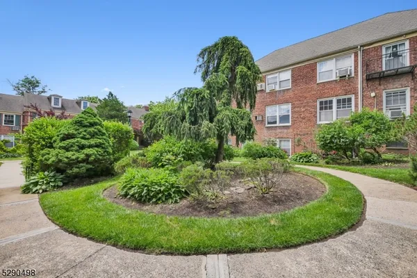 a view of a garden with a house