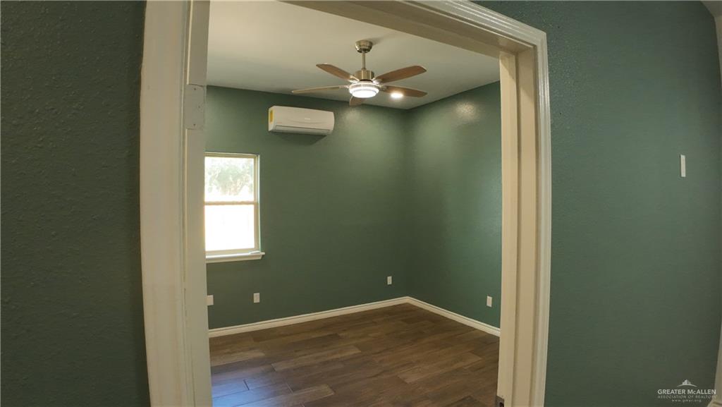 1421 South Dallas Street Alton, TX 78573 - Photo 4 of 7 a view of an empty room with a window