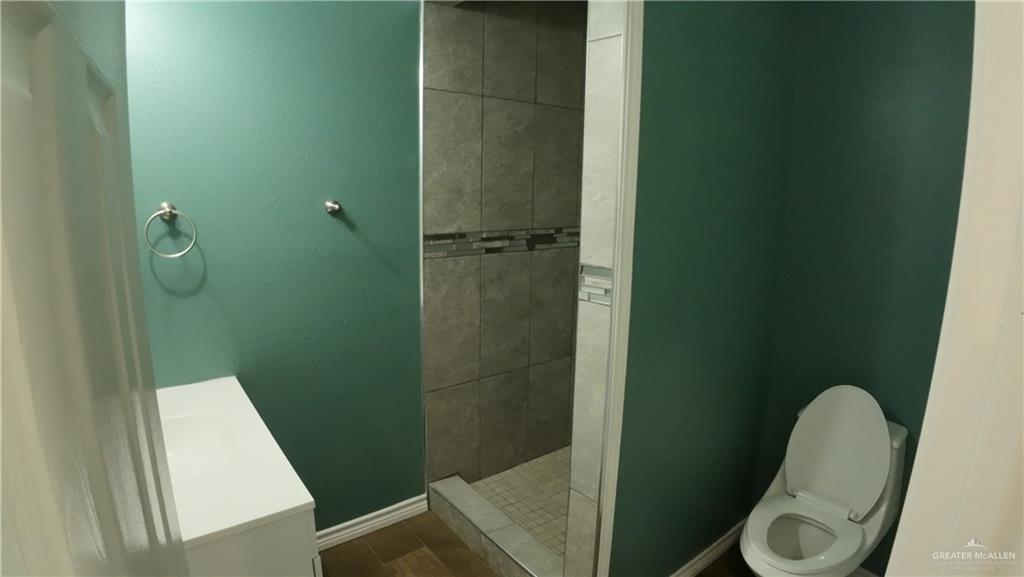 1421 South Dallas Street Alton, TX 78573 - Photo 6 of 7 a bathroom with a shower and toilet