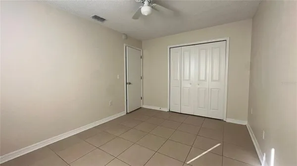 an empty room with a ceiling fan