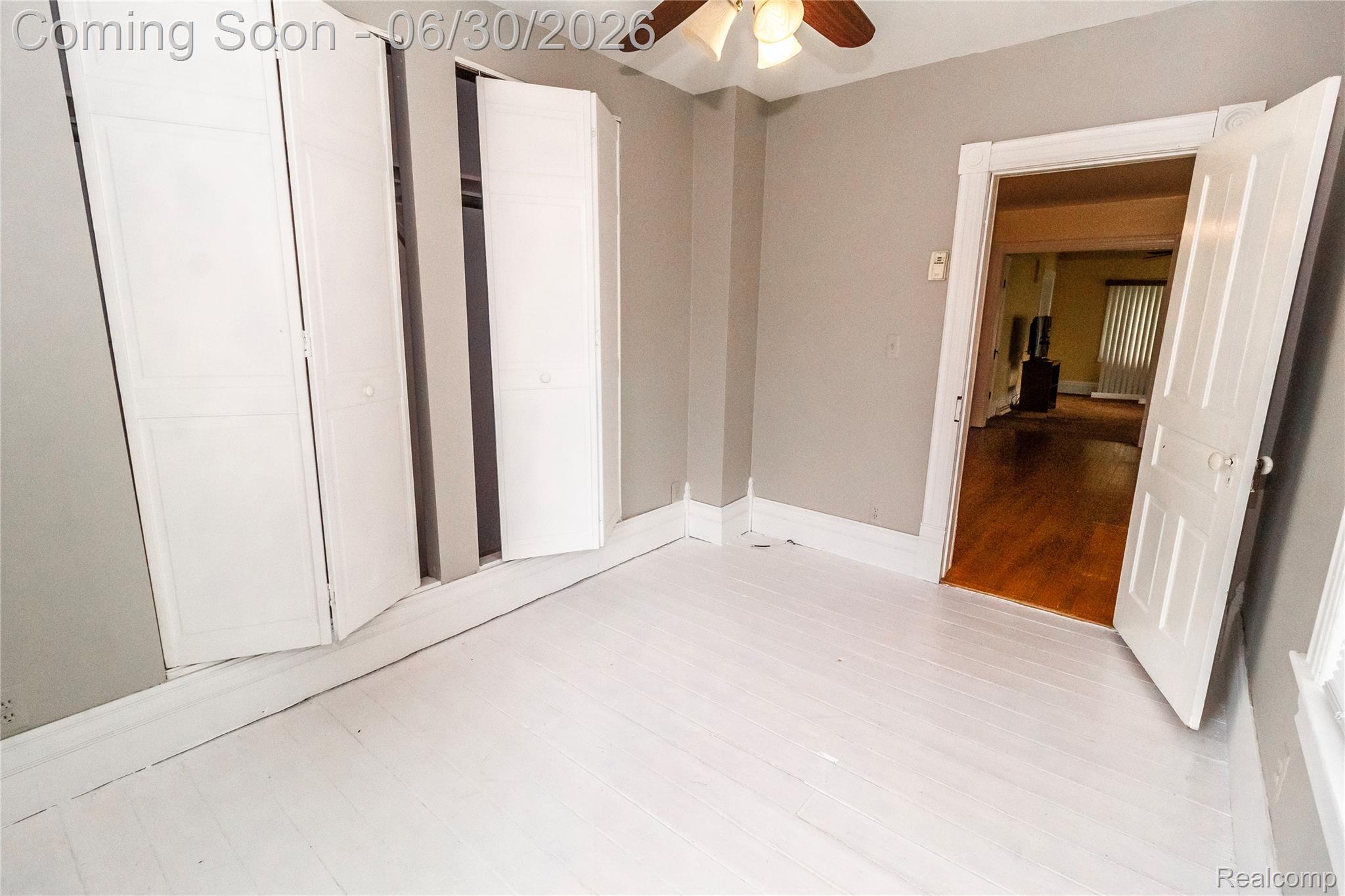 8150 Norman Road Imlay City, MI 48444 - Photo 19 of 58 Room featuring painted wood-finish flooring, light gray wall paint, and white baseboards