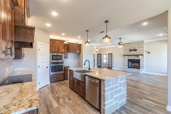 a kitchen with a stove and a wooden floor