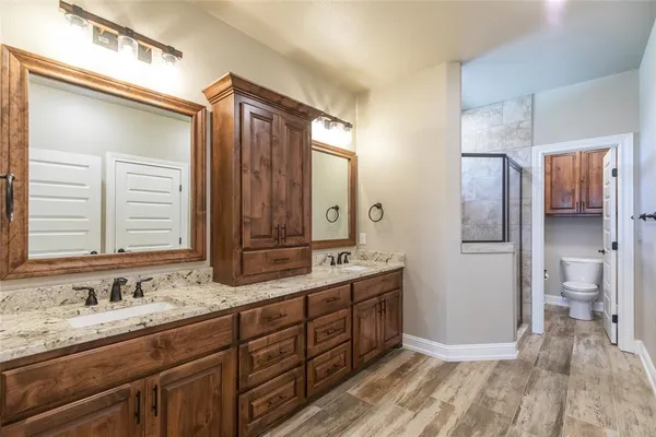 a bathroom with a granite countertop sink mirror and double