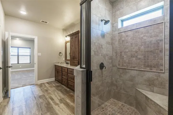a bathroom with a shower and a sink