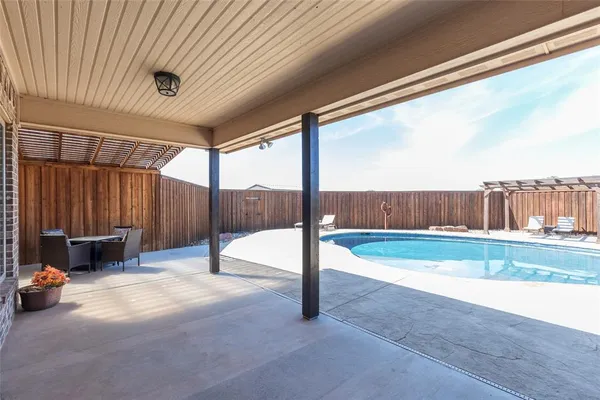a view of a backyard with wooden fence