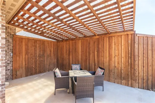 a view of a patio with a table and chairs