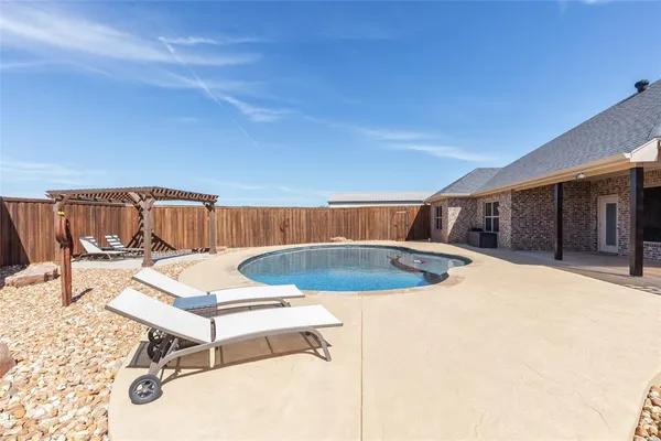 a view of a swimming pool with a lounge chair