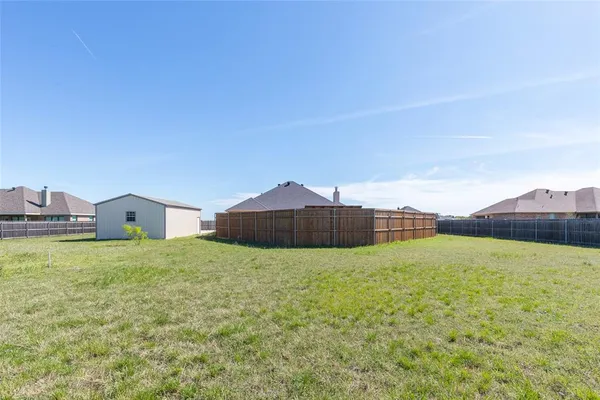 a house with a yard and a large tree