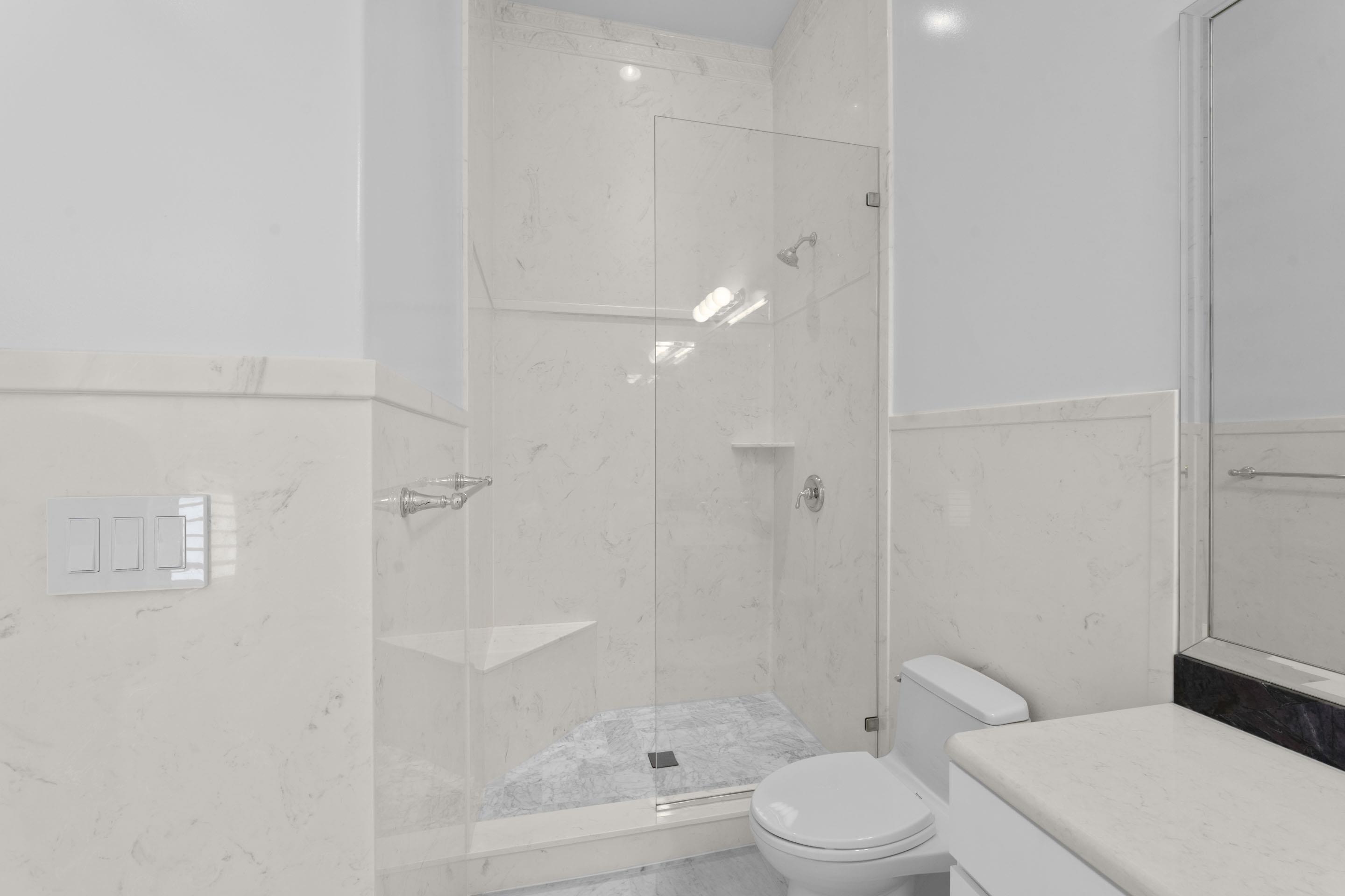 881 Bray Station Road Collierville, TN 38017 - Photo 14 of 40 Full bath featuring vanity, a marble finish shower, tile walls, and a wainscoted wall