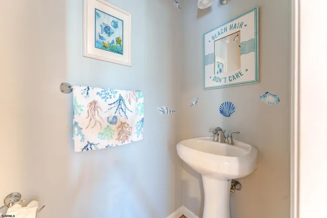 a spacious bedroom with a bed and a chandelier