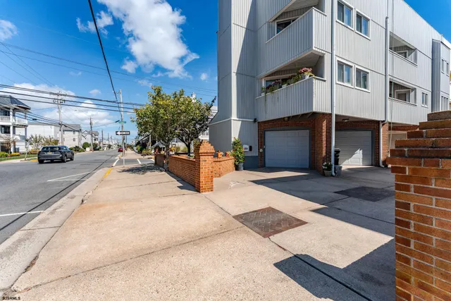 a view of a brick house with many windows