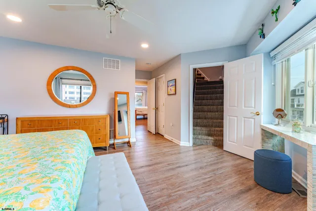 a roof deck with a dining table and chairs with wooden floor