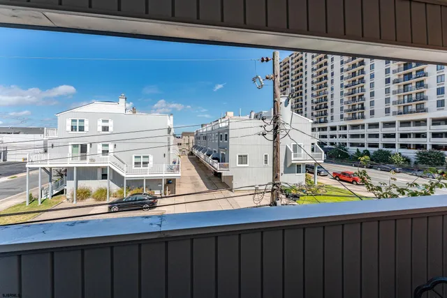 an aerial view of a house with parking