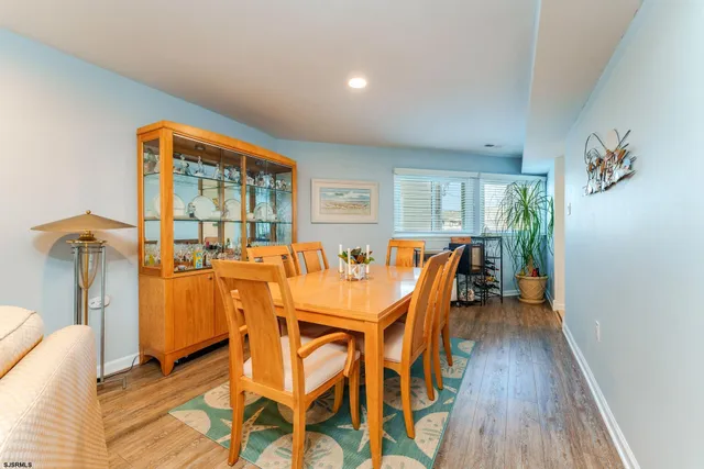 a kitchen with kitchen island a counter top space a sink stainless steel appliances and cabinets