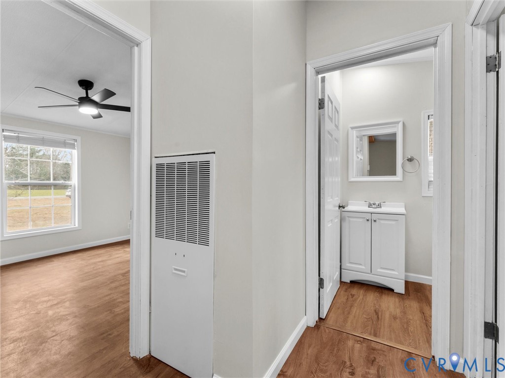 4772 Carsley Road Waverly, VA 23890 - Photo 20 of 38 Hall featuring a heating unit and wood finished fl