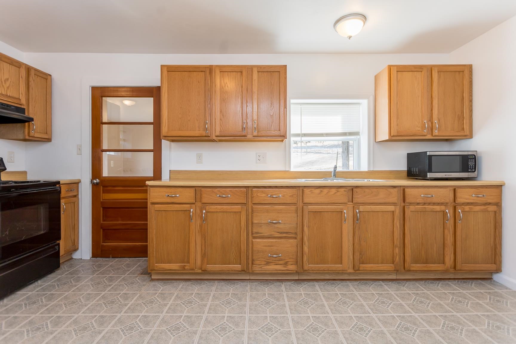 7176 Winestore Road Timberville, VA 22853 - Photo 18 of 45 a kitchen with white cabinets and sink