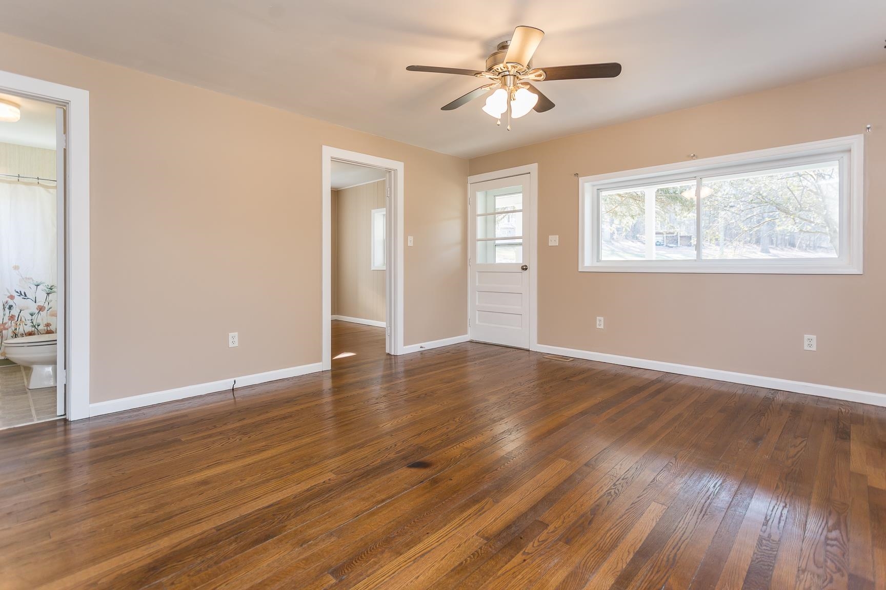 7176 Winestore Road Timberville, VA 22853 - Photo 7 of 45 a view of an empty room with wooden floor and a window
