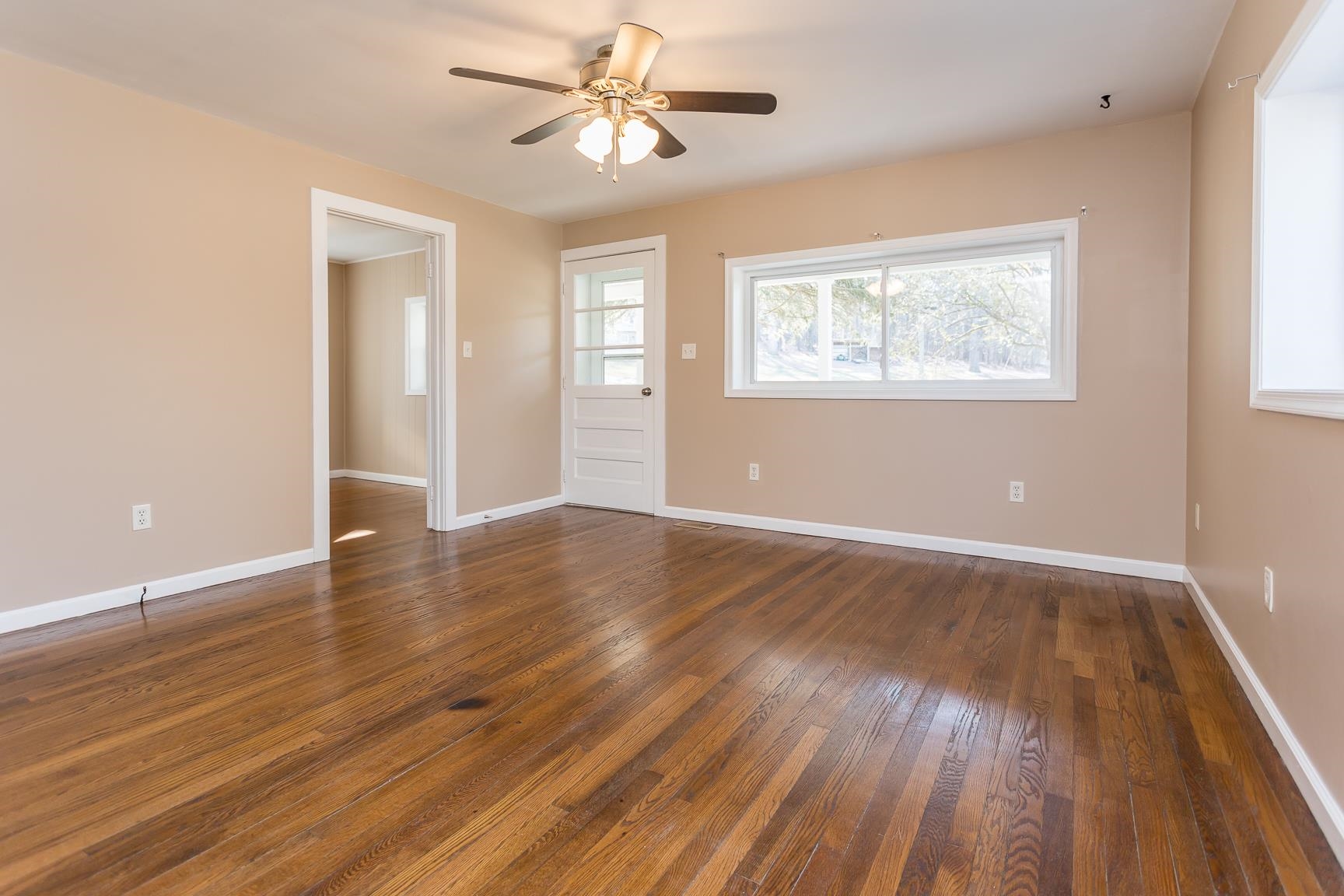 7176 Winestore Road Timberville, VA 22853 - Photo 8 of 45 a view of an empty room with wooden floor and a window