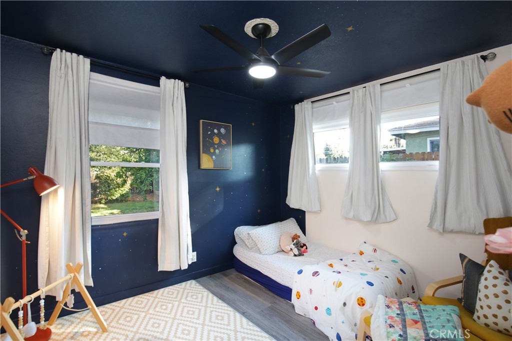 3445 Tipperary Way Riverside, CA 92506 - Photo 15 of 26 a bedroom with a bed and wooden floor