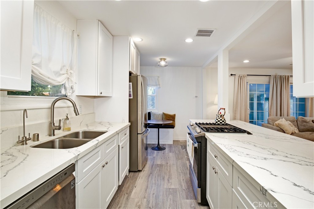 3445 Tipperary Way Riverside, CA 92506 - Photo 6 of 26 a kitchen with stainless steel appliances granite countertop a sink stove and refrigerator