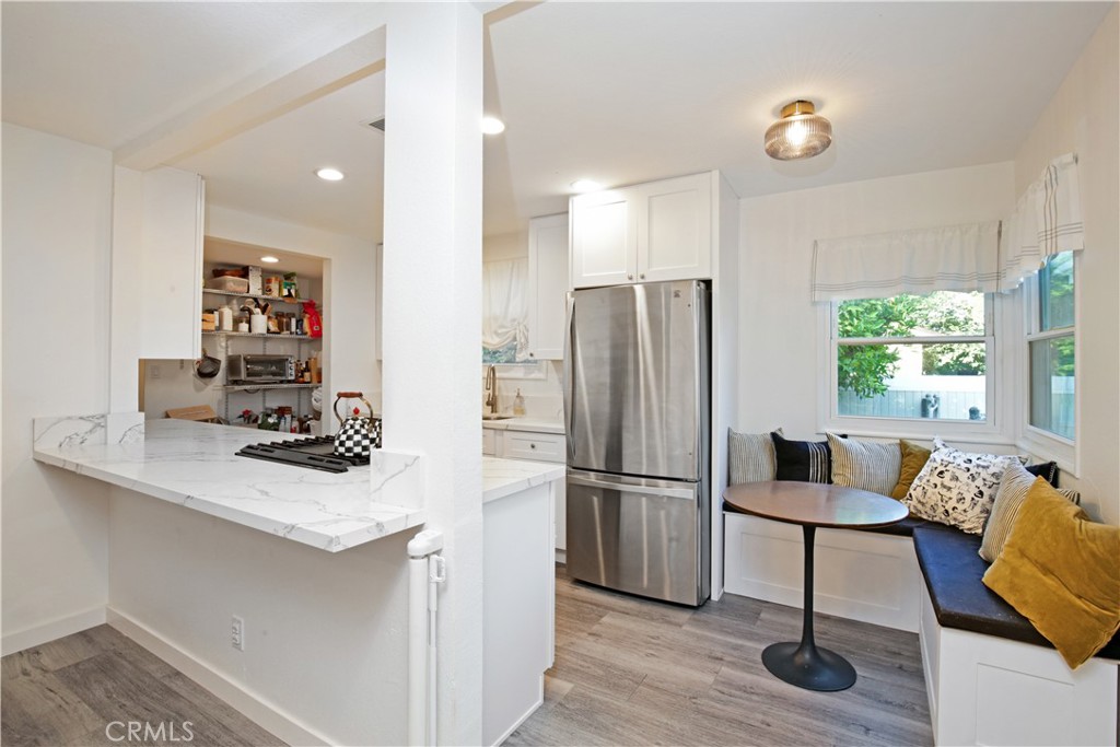 3445 Tipperary Way Riverside, CA 92506 - Photo 7 of 26 a kitchen with a refrigerator and a stove top oven