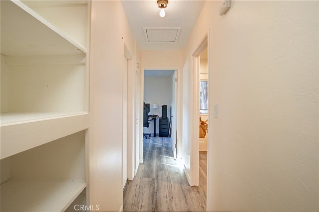 3445 Tipperary Way Riverside, CA 92506 - Photo 8 of 26 a view of a hallway with wooden floor and a living room