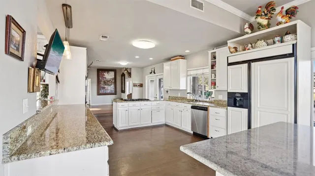 a large kitchen with cabinets and stainless steel appliances