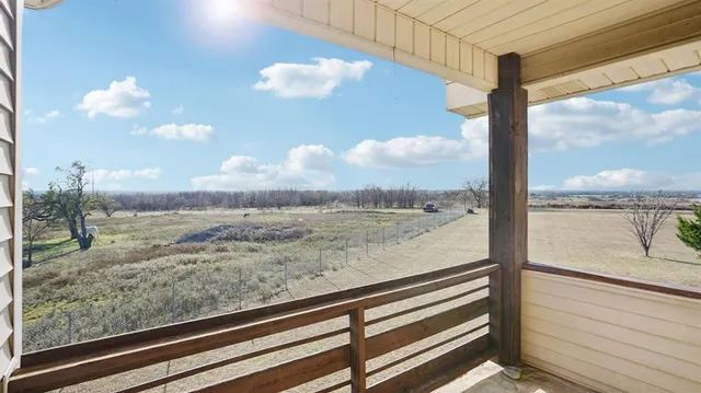 a view of a floor to ceiling window and a wooden floor