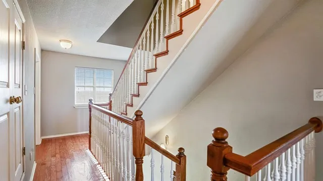 a view of entryway and hall with wooden floor