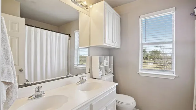 a bathroom with a sink a toilet and tub