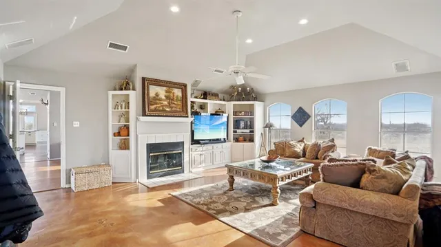a living room with fireplace furniture and a flat screen tv