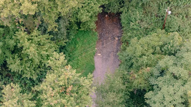 an aerial view of a house with a yard