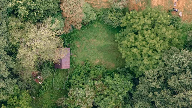 an aerial view of a house with a yard