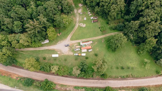 an aerial view of a forest with houses