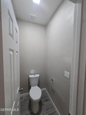 a white toilet sitting in a bathroom