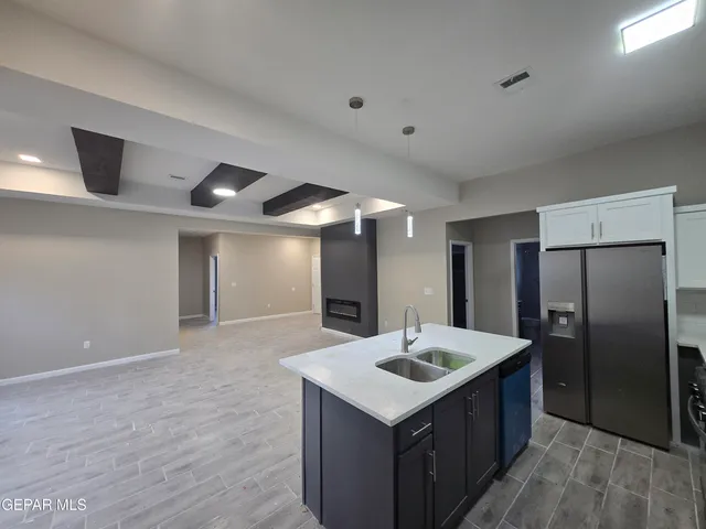a kitchen with a sink and refrigerator