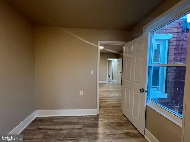 a view of a hallway with wooden floor