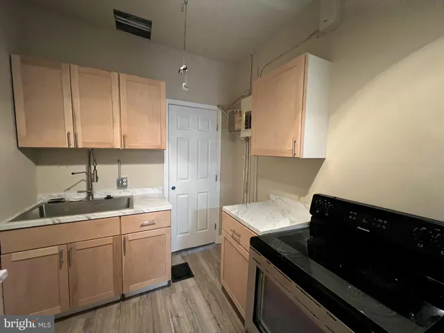 a kitchen with a sink dishwasher and stove