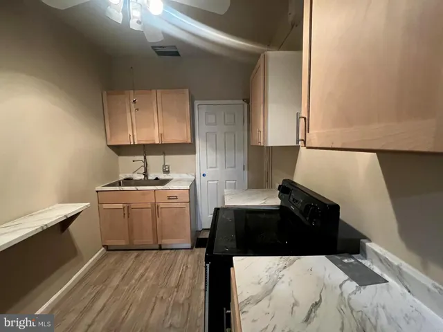 a kitchen with a refrigerator and a stove