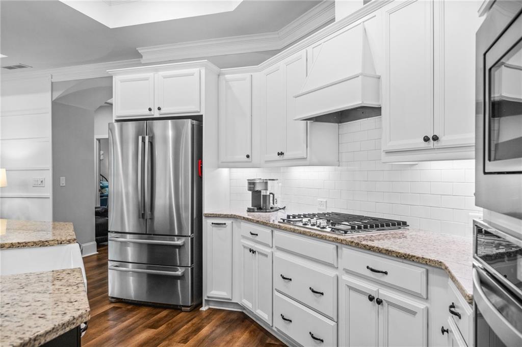 4883 Pleasantry Way Northwest Acworth, GA 30101 - Photo 13 of 46 a kitchen with granite countertop a refrigerator and a stove top oven