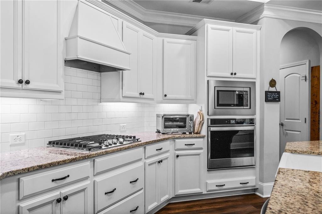 4883 Pleasantry Way Northwest Acworth, GA 30101 - Photo 14 of 46 a kitchen with granite countertop a stove and a refrigerator