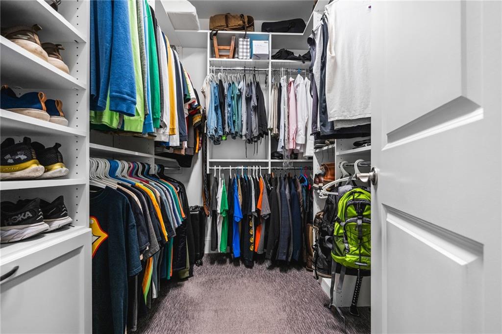 4883 Pleasantry Way Northwest Acworth, GA 30101 - Photo 21 of 46 a view of walk in closet with clothes and shoes