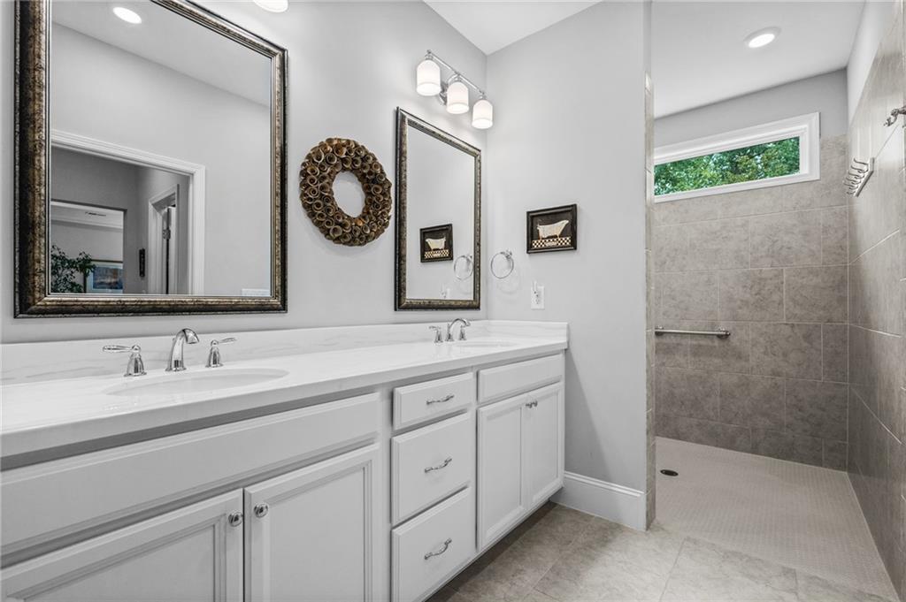 4883 Pleasantry Way Northwest Acworth, GA 30101 - Photo 22 of 46 a bathroom with a double vanity sink and a mirror